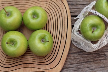 green apples is delicious on wood background.