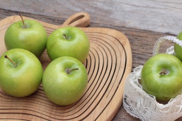 green apples is delicious on wood background.