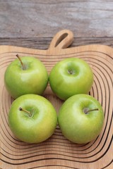 green apples is delicious on wood background.