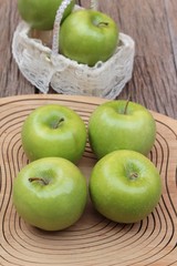 green apples is delicious on wood background.