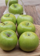 green apples is delicious on wood background.