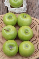 green apples is delicious on wood background.