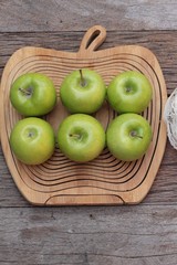 green apples is delicious on wood background.