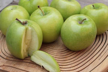 green apples is delicious on wood background.