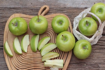 green apples is delicious on wood background.