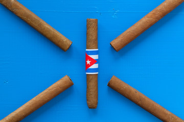 Detail of luxury Cuban cigars on the blue table
