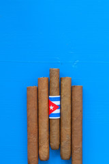 Detail of luxury Cuban cigars on the blue table