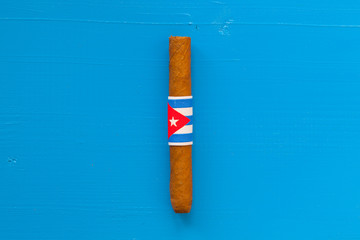 Detail of luxury Cuban cigars on the blue table