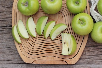 green apples is delicious on wood background.