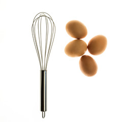Metal whisk and eggs for a minimalist composition
