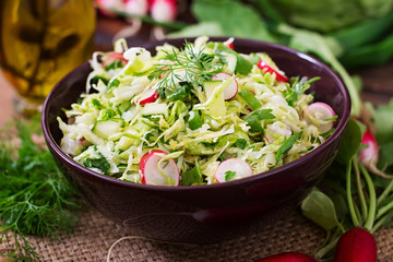 Vitamin salad of young vegetables: cabbage, radish, cucumber and fresh herbs