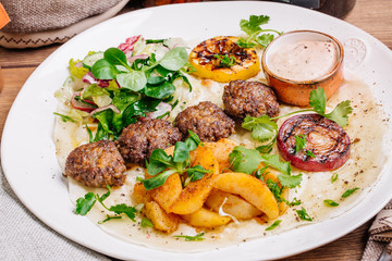 Plate of arabic kebab meat with grilled vegetables