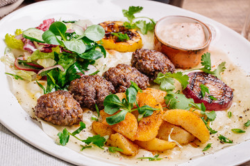 Plate of arabic kebab meat with grilled vegetables
