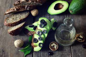 avocado bread olives on a wooden background