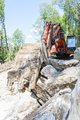 Fototapeta premium Excavator with big shovel to work with rocks