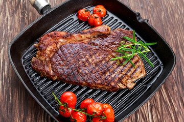 Grilled Beef Sirloin Steak on iron pan with vegetables.