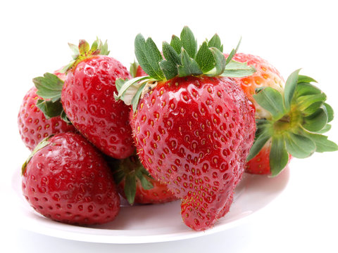 Red strawberries on white plate
