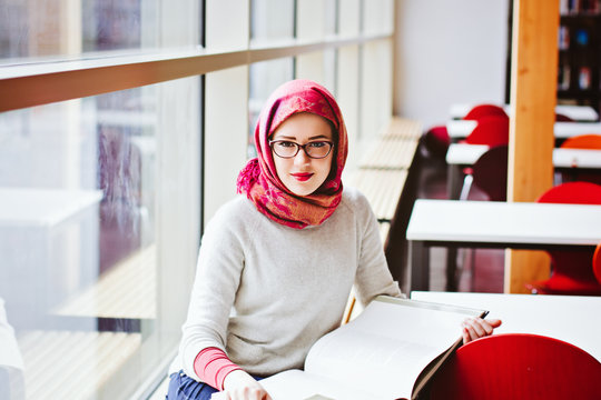 Girl in red head scarf with book