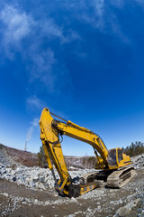 Heavy equipment, Excavator at work with blue sky as bakground