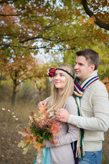 Autumn wedding in boho style. Autumn leaf fall, autumnal forest. loving couple, man and woman. orange pumpkin