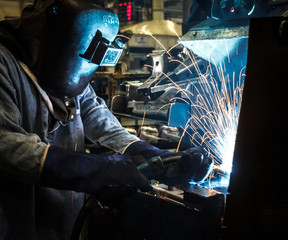 Industrial steel worker speeds motion in factory
