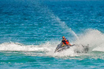 Obraz premium Young Man on Jet Ski, Tropical Ocean, Vacation Concept