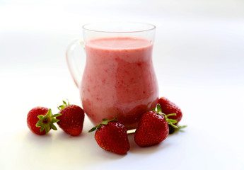 Strawberry tasty smoothies in the transparent glass on the white background