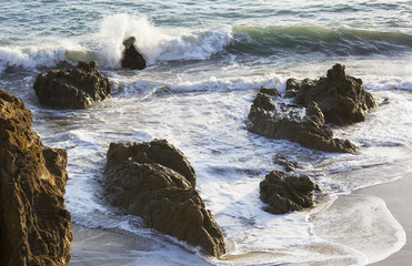 The waves of the Pacific ocean, the beach landscape. The ocean and waves during strong winds in United States, Santa Monica. Waves breaking on the rocks.
