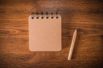 Wood table with  notebook and pencil