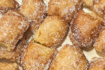 Pastry pieces with sugar close up on a plate