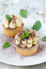 Tiramisu Cupcakes decorated with mint and cocoa powder
