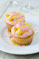 Cupcake frosted with pink cream and sugar decoration