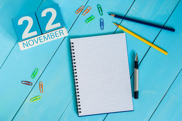 November 22nd. Image of november 22 wooden color calendar on blue background. Autumn day. Empty space for text