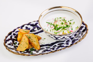 Okroshka - a traditional Russian soup from cucumbers, radishes,