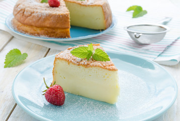 Japanese cheesecake decorated with mint, icing sugar and strawberry