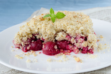Cherry crumble pie on white plate