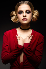 Beautiful girl in a red dress with a deep neckline and black rings on his fingers. The model with bright makeup. Was was made in the studio.