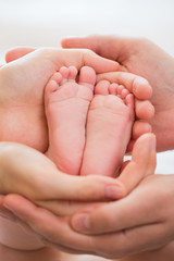 baby foot in the hands of parents