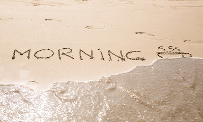 Abstract hand writing on the sand word Morning