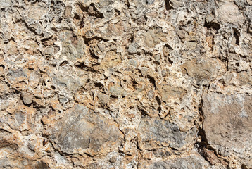 Ancient roughness stone wall.  Beige  texture. Can be used as background