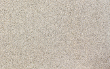 Fototapeta na wymiar Wet sand. Beige granular texture. Can be used as background