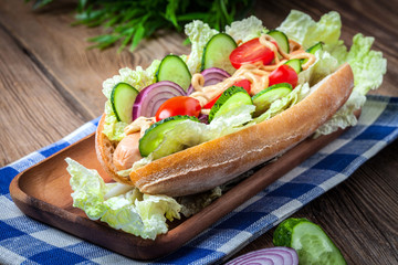 Homemade sandwich on a wooden table.