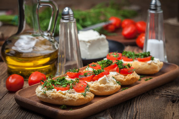 Delicious bruschetta with tomatoes, feta cheese, dill and spice