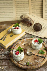 Chia seed pudding with raspberries chocolate and mint in jars. Vertical shooting.