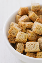 croutins in white dish on white background