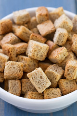 croutins in white dish on blue background