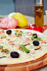 Big tasty pizza with seafood, shrimp on a wooden table