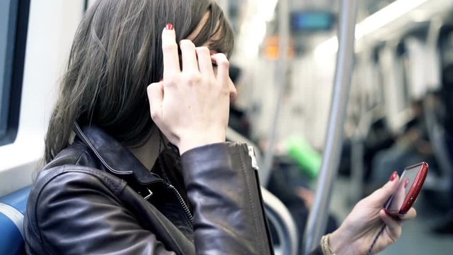 Happy, woman watching movie on smartphone during metro ride
