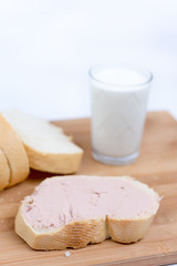 Obraz na płótnie Canvas Pate on the bread, glass with yogurt on the wooden board