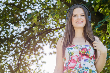 Young girl in colorful blouses listening to music